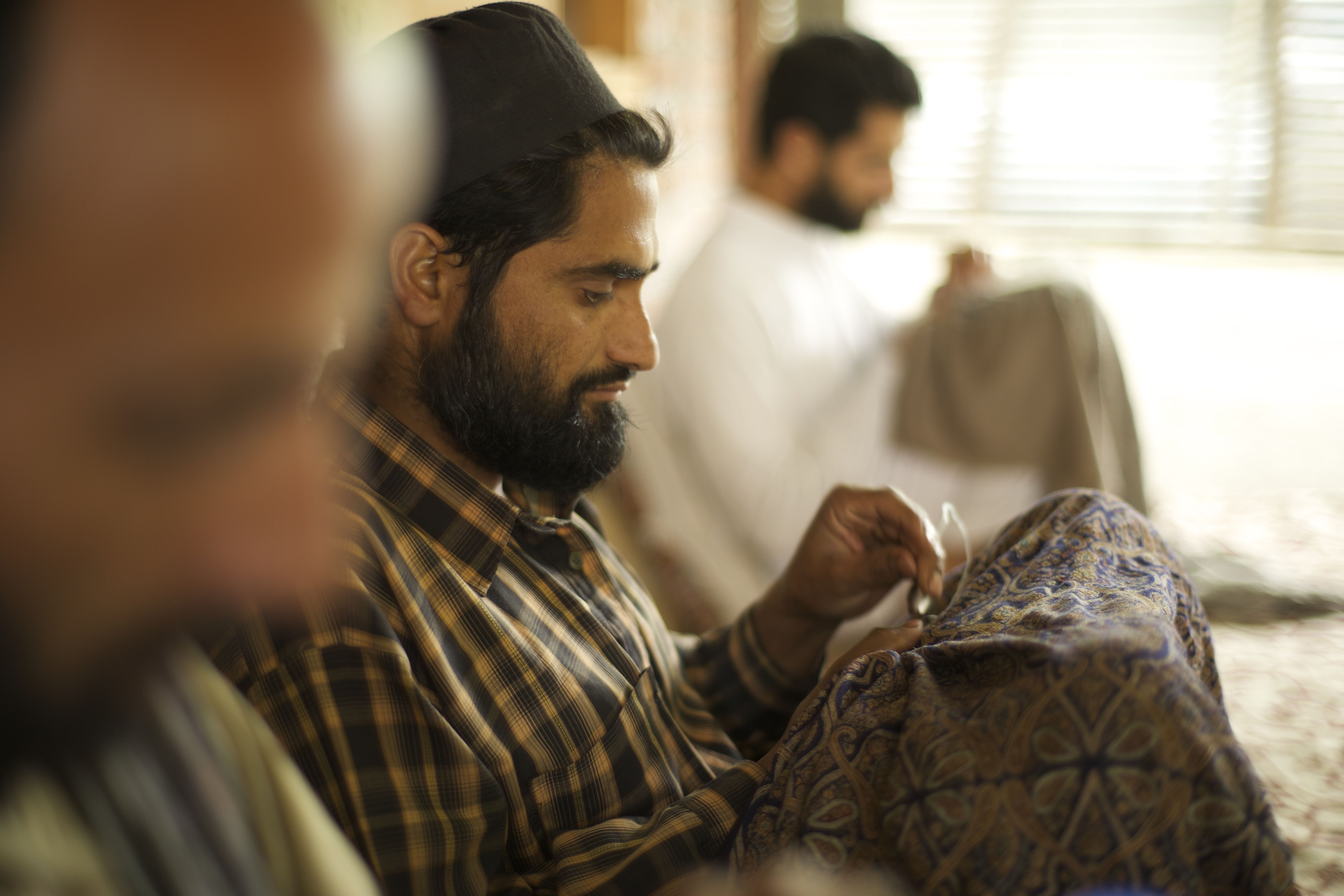 Kashmiri-Meisterhandwerker beim Besticken eines Meisterstücks